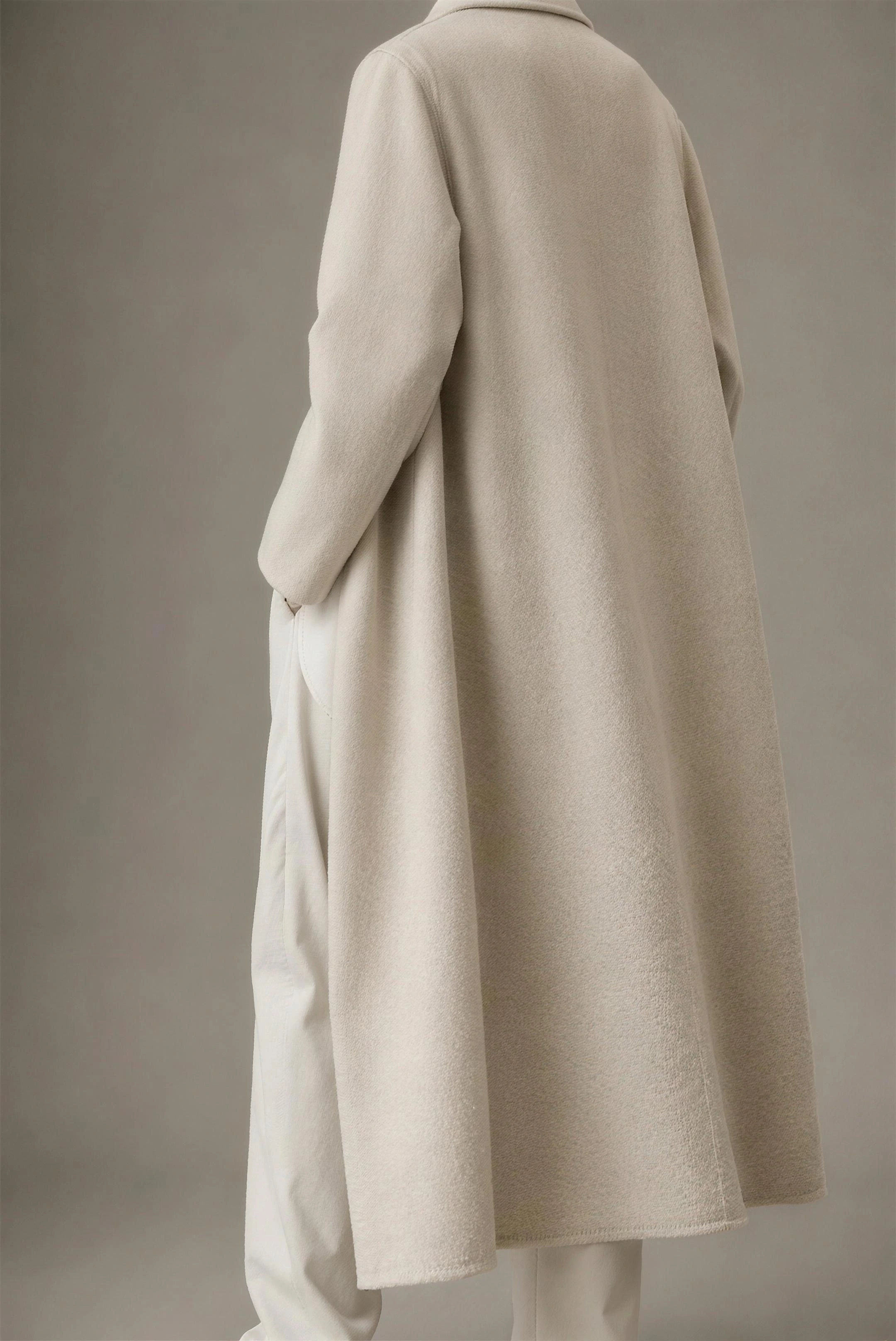 Back view of the agnes coat, an oat double-faced recycled-wool overcoat worn open