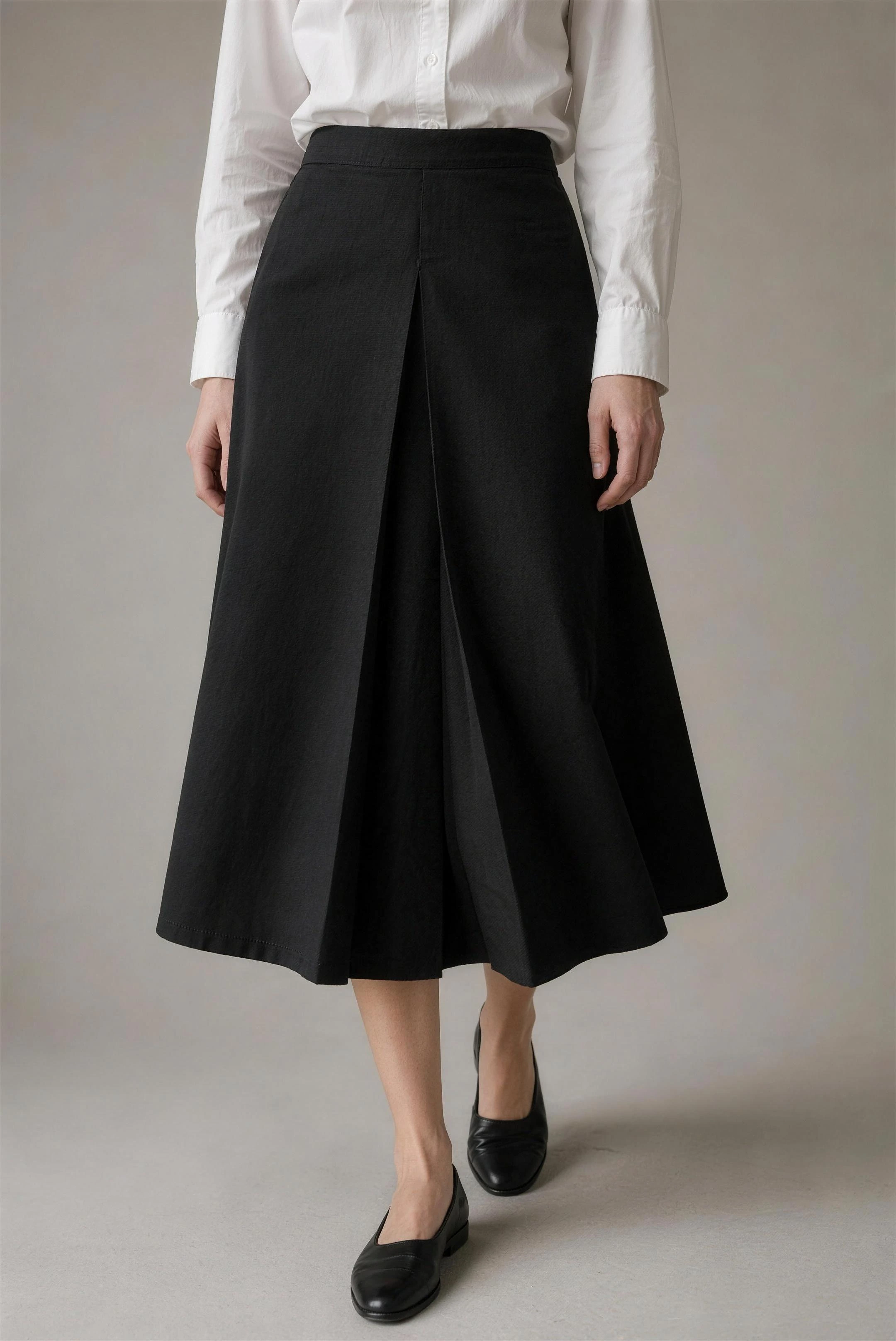 Ink cotton-twill lena skirt with a deep single pleat, cropped ribcage to mid-calf